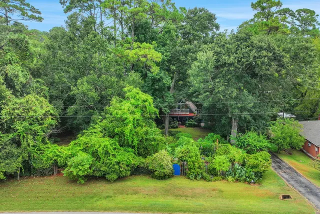 an aerial view of a house with a yard and lake view