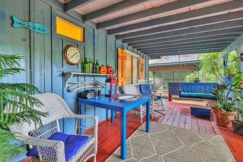 a kitchen with stainless steel appliances granite countertop a refrigerator a stove a sink and a dining table with wooden floor