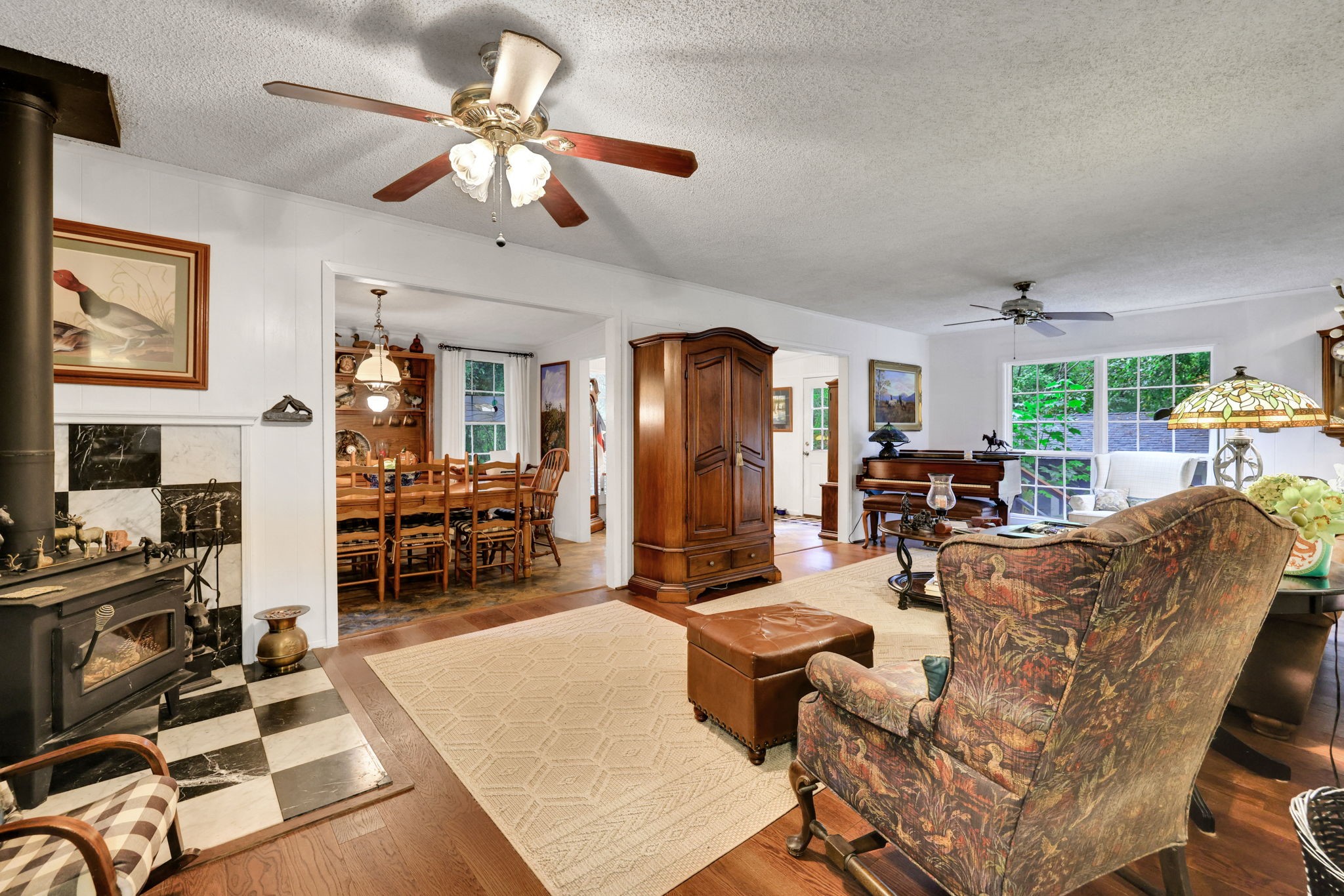 300 Timber Lane Coldspring, TX 77331 - Photo 10 of 43 a living room with furniture a chandelier and a dining table with wooden floor