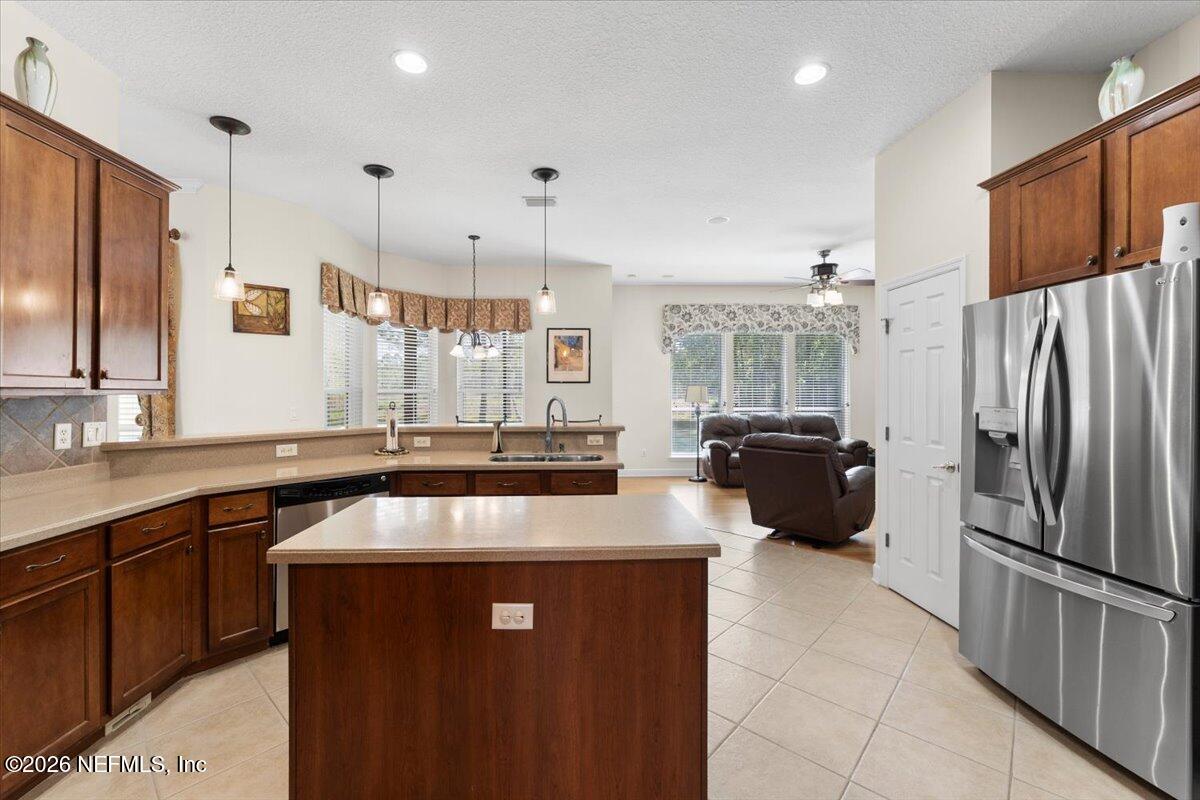 1112 Hawk Watch Circle St. Augustine, FL 32092 - Photo 16 of 49 a kitchen with kitchen island a counter top space a sink stainless steel appliances and cabinets