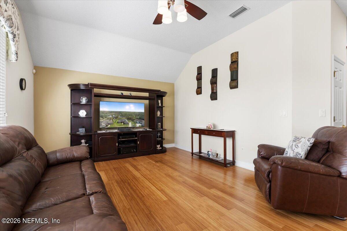 1112 Hawk Watch Circle St. Augustine, FL 32092 - Photo 22 of 49 a living room with furniture and a flat screen tv