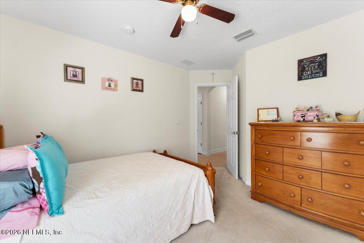 1112 Hawk Watch Circle St. Augustine, FL 32092 - Photo 26 of 49 a bedroom with a bed and a dresser