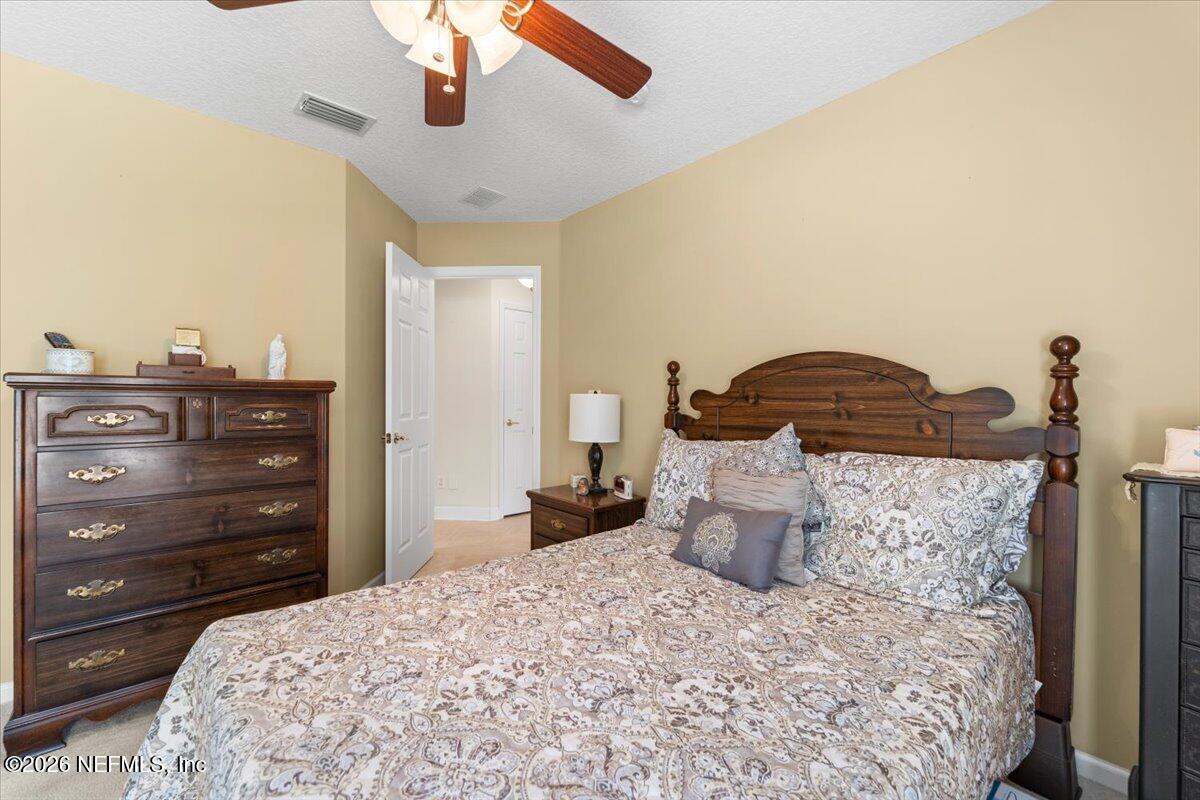 1112 Hawk Watch Circle St. Augustine, FL 32092 - Photo 29 of 49 a bedroom with a bed and cabinets