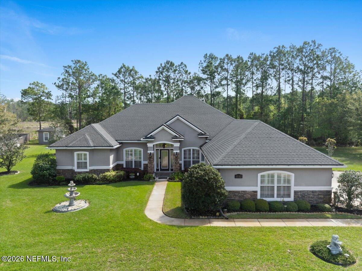1112 Hawk Watch Circle St. Augustine, FL 32092 - Photo 3 of 49 a front view of a house with a yard