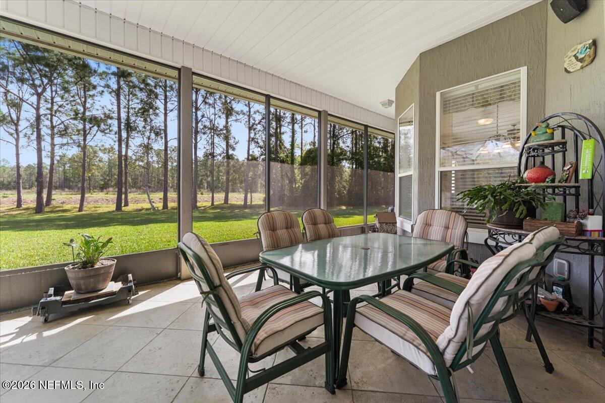 1112 Hawk Watch Circle St. Augustine, FL 32092 - Photo 31 of 49 a patio with a table and chairs