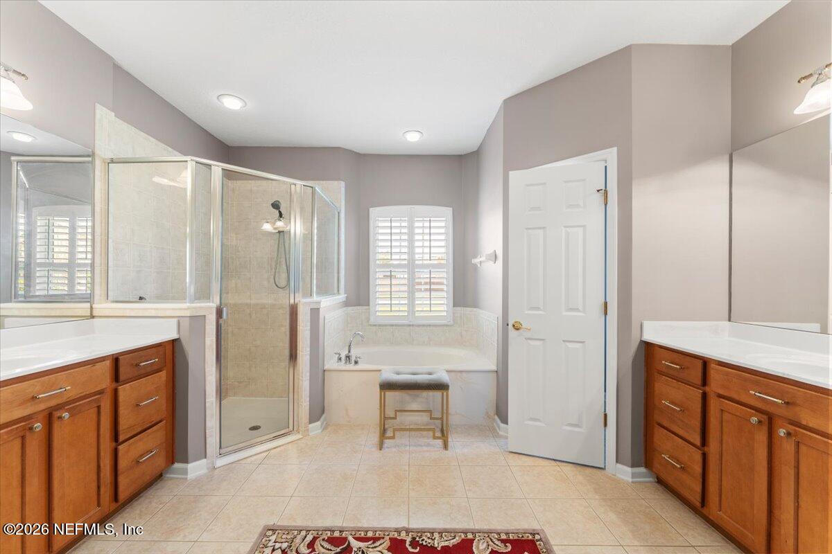 1112 Hawk Watch Circle St. Augustine, FL 32092 - Photo 34 of 49 a spacious bathroom with a shower sink and mirror