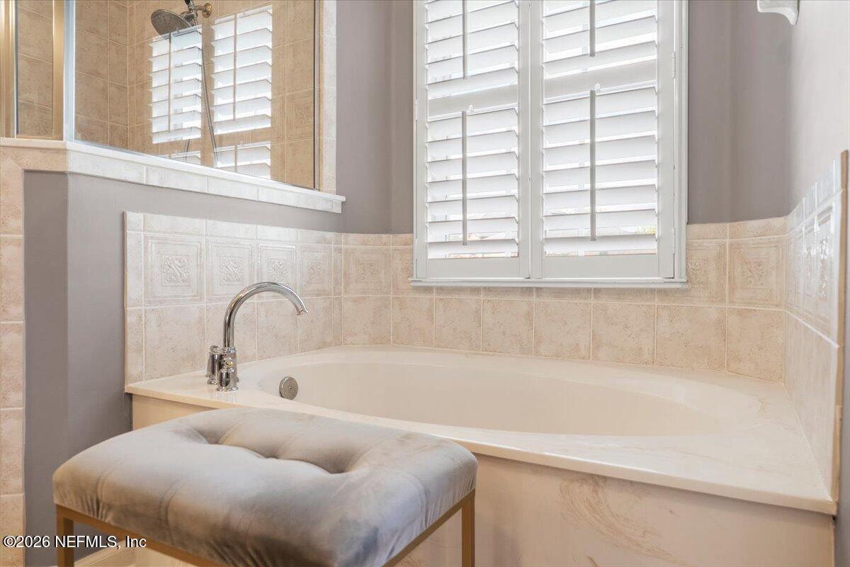 1112 Hawk Watch Circle St. Augustine, FL 32092 - Photo 36 of 49 a bathroom with bathtub and window