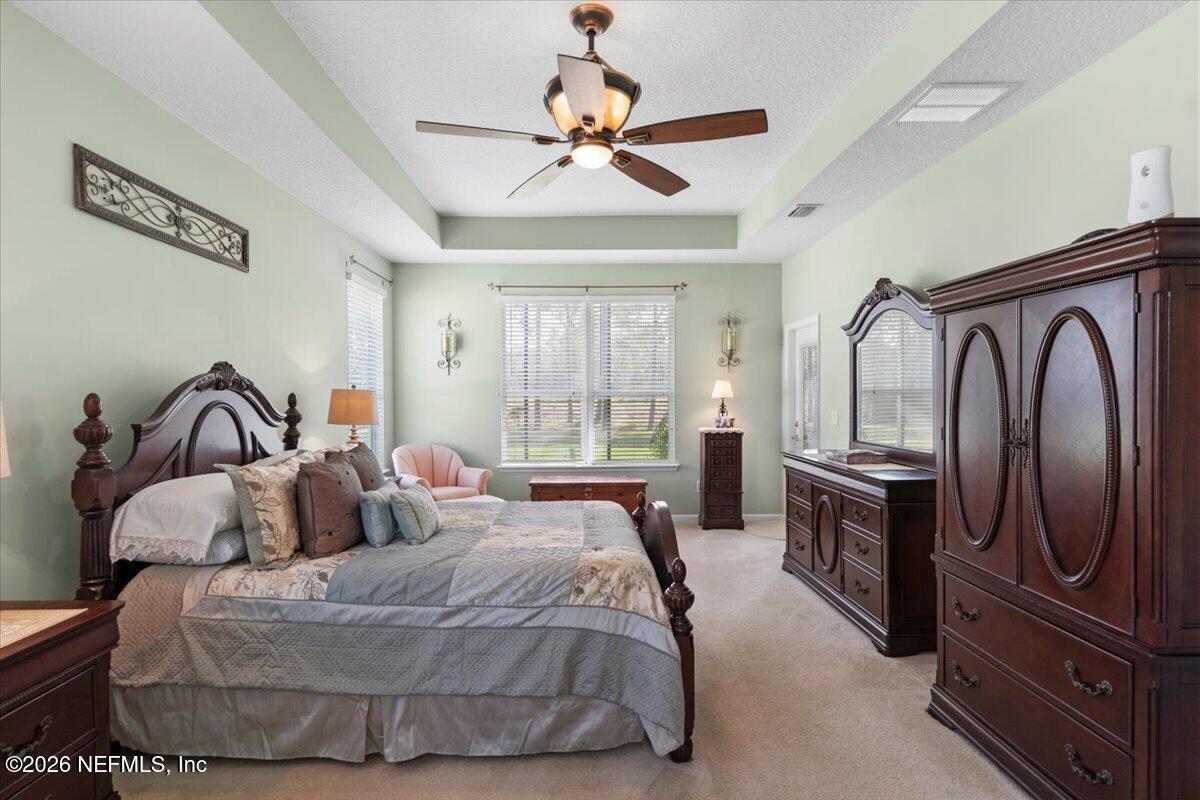 1112 Hawk Watch Circle St. Augustine, FL 32092 - Photo 37 of 49 a bedroom with a bed and dresser with mirror