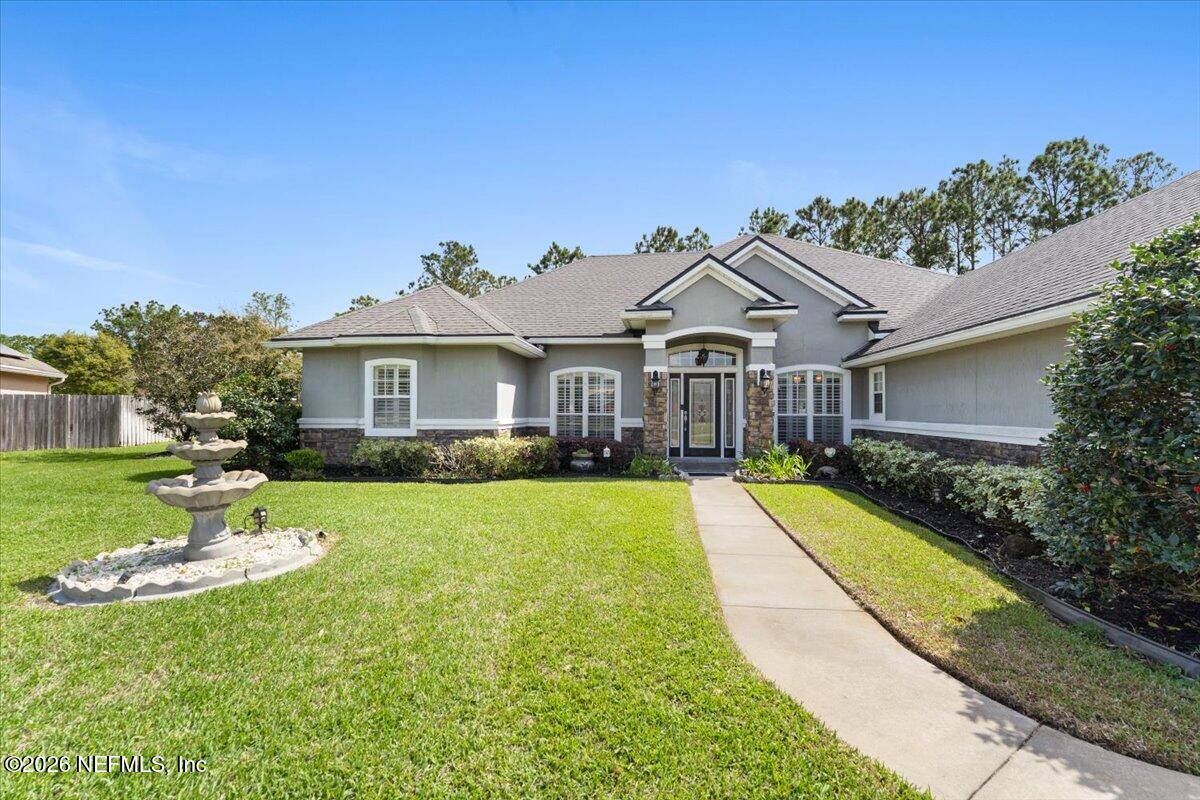 1112 Hawk Watch Circle St. Augustine, FL 32092 - Photo 4 of 49 a front view of a house with swimming pool having outdoor seating