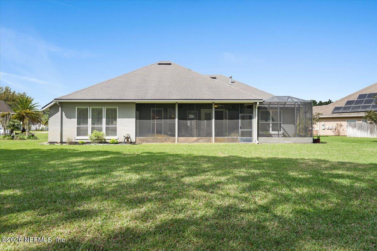 1112 Hawk Watch Circle St. Augustine, FL 32092 - Photo 41 of 49 a front view of a house with a garden
