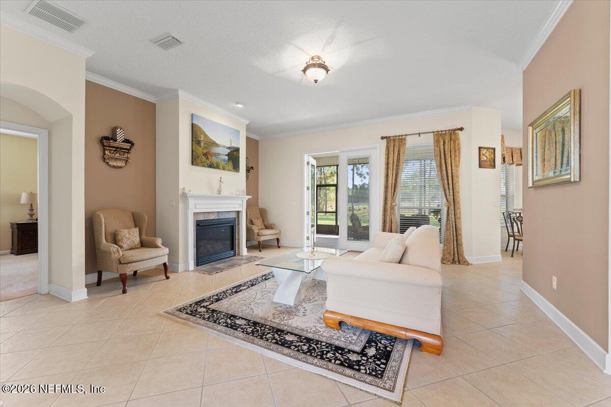 1112 Hawk Watch Circle St. Augustine, FL 32092 - Photo 10 of 49 a living room with furniture a large window and a fireplace