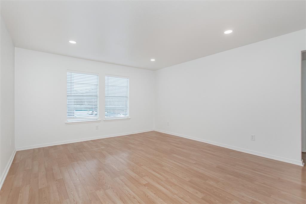 6061 Milton Street, Unit 231 Dallas, TX 75206 - Photo 16 of 27 Bright secondary bedroom with updated flooring, recessed lighting, and generous space for guests, roommates, or a home office.