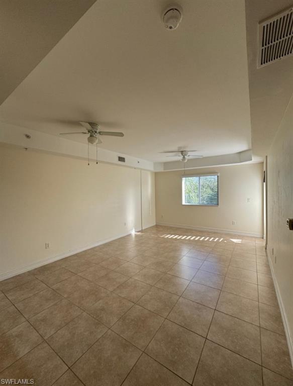 1100 Pine Ridge Road, Unit A302 Naples, FL 34108 - Photo 3 of 12 an empty room with a empty space and windows