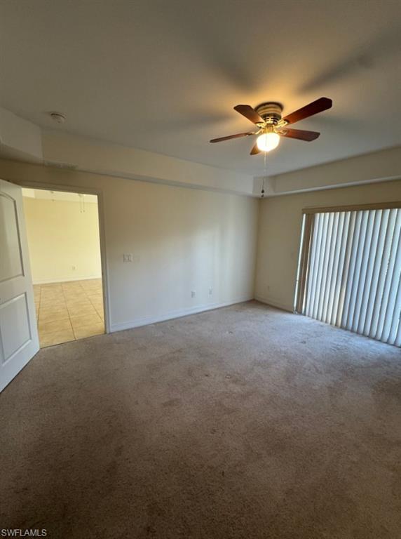 1100 Pine Ridge Road, Unit A302 Naples, FL 34108 - Photo 9 of 12 a view of a livingroom with a fan & a window