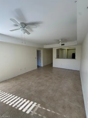 an empty room with a empty space and windows