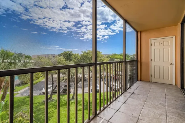 a view of a porch with a floor to ceiling window next to a yard
