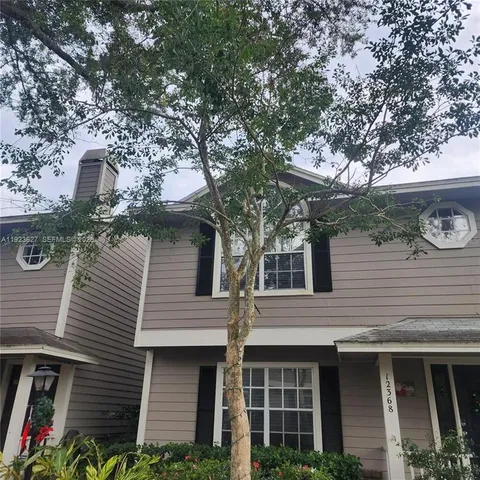 a view of a house with a tree