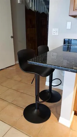 a close view of table chair and stove