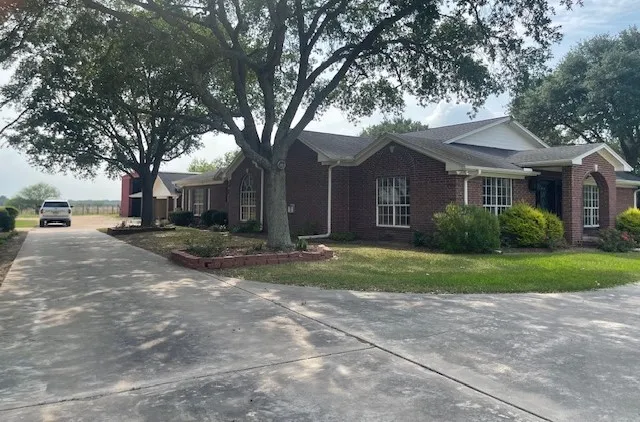 a front view of house with yard and green space
