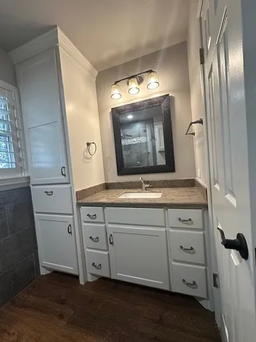 a bathroom with a double vanity sink and a mirror