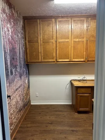 a room with wooden floor and windows