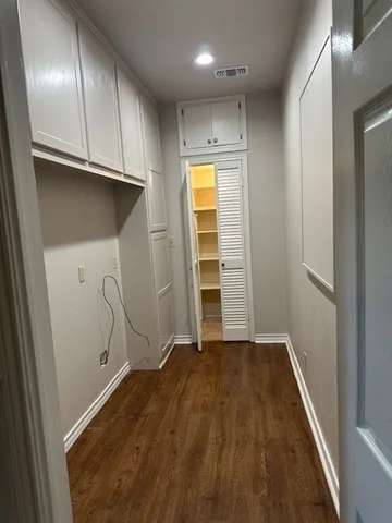 a kitchen with granite countertop a sink cabinets and stainless steel appliances