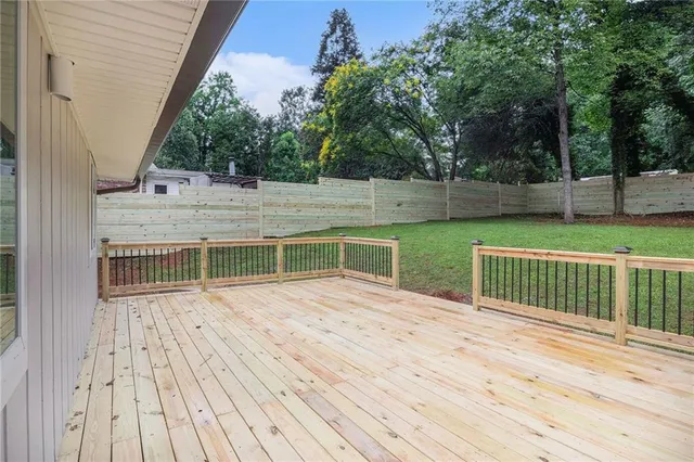 a view of balcony with deck and yard