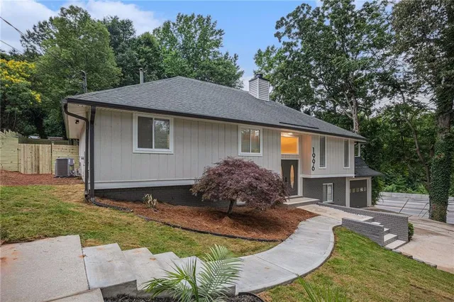 a aerial view of a house with a yard and garage
