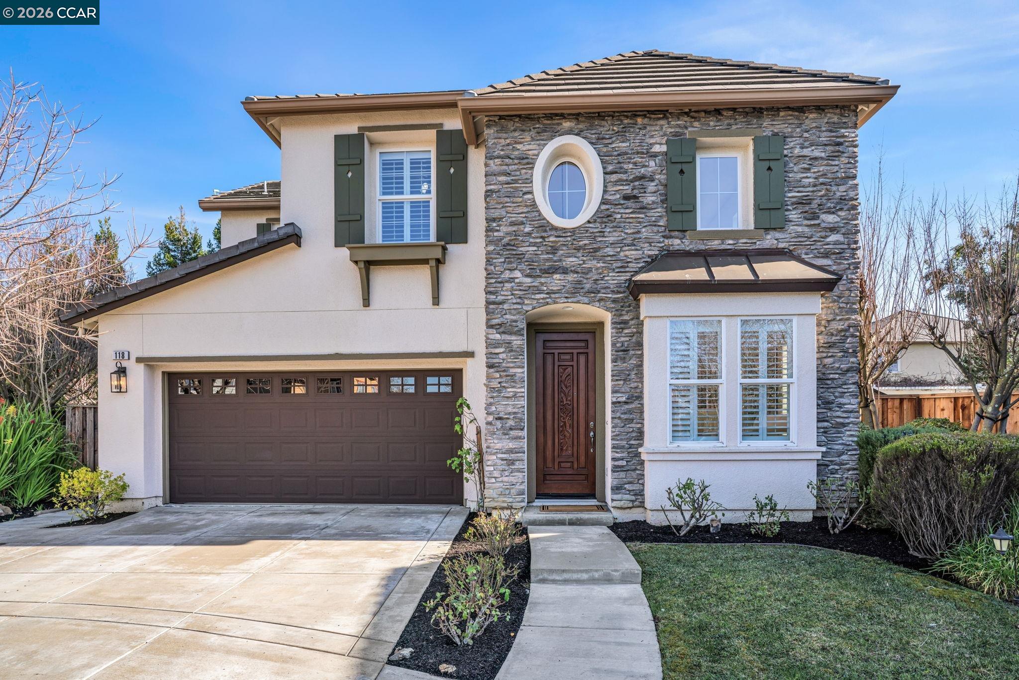 a front view of a house with a garden