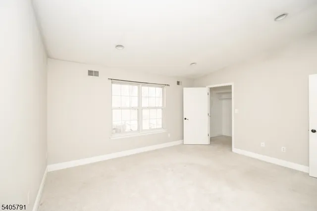 an empty room with a empty space and windows