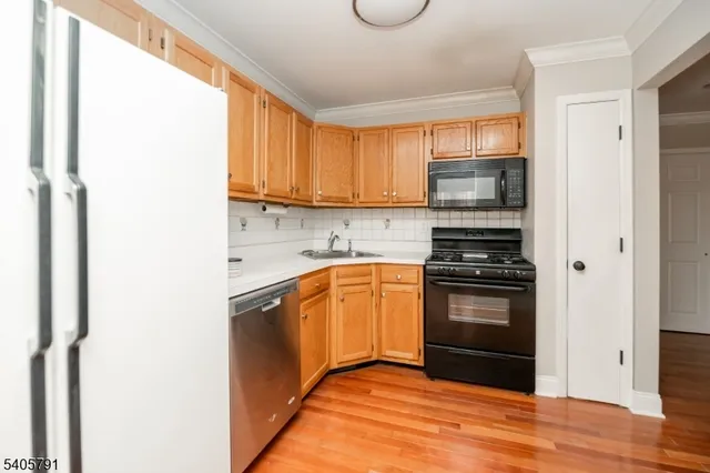 a kitchen with a sink appliances and cabinets