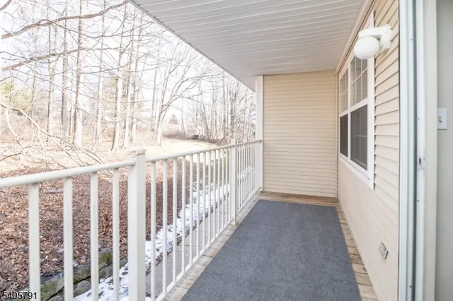 a view of a porch with wooden floor and fence