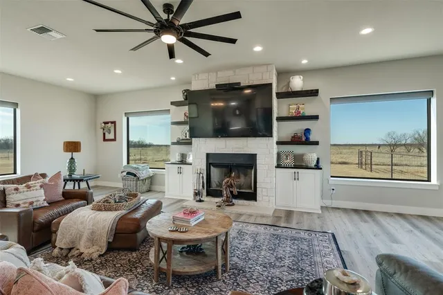 a living room with furniture a fireplace and a flat screen tv