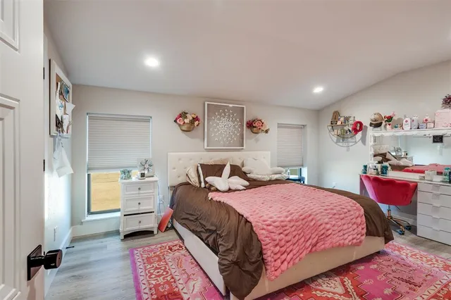 a bedroom with a bed and a couch