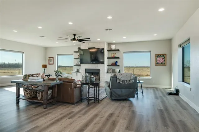 a living room with fireplace furniture and a wooden floor