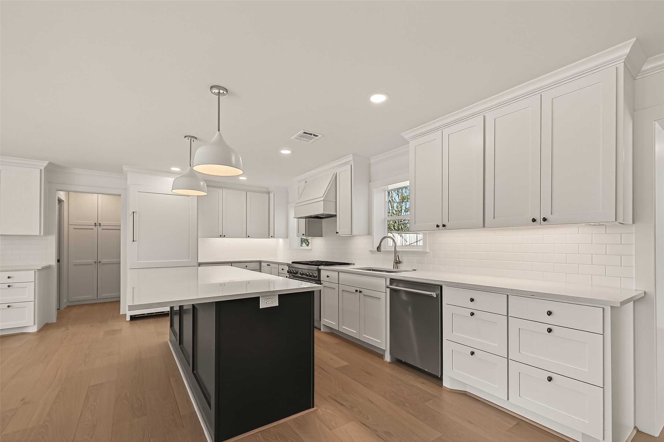 9242 Autauga Street Houston, TX 77080 - Photo 13 of 49 a kitchen with a sink window and cabinets