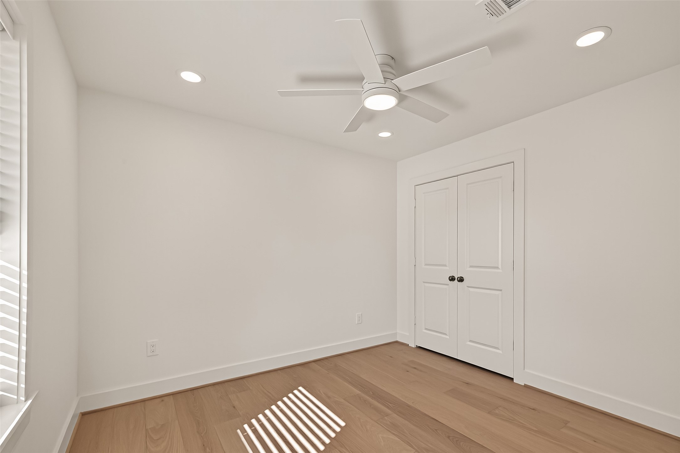 9242 Autauga Street Houston, TX 77080 - Photo 19 of 49 an empty room with wooden floor and windows