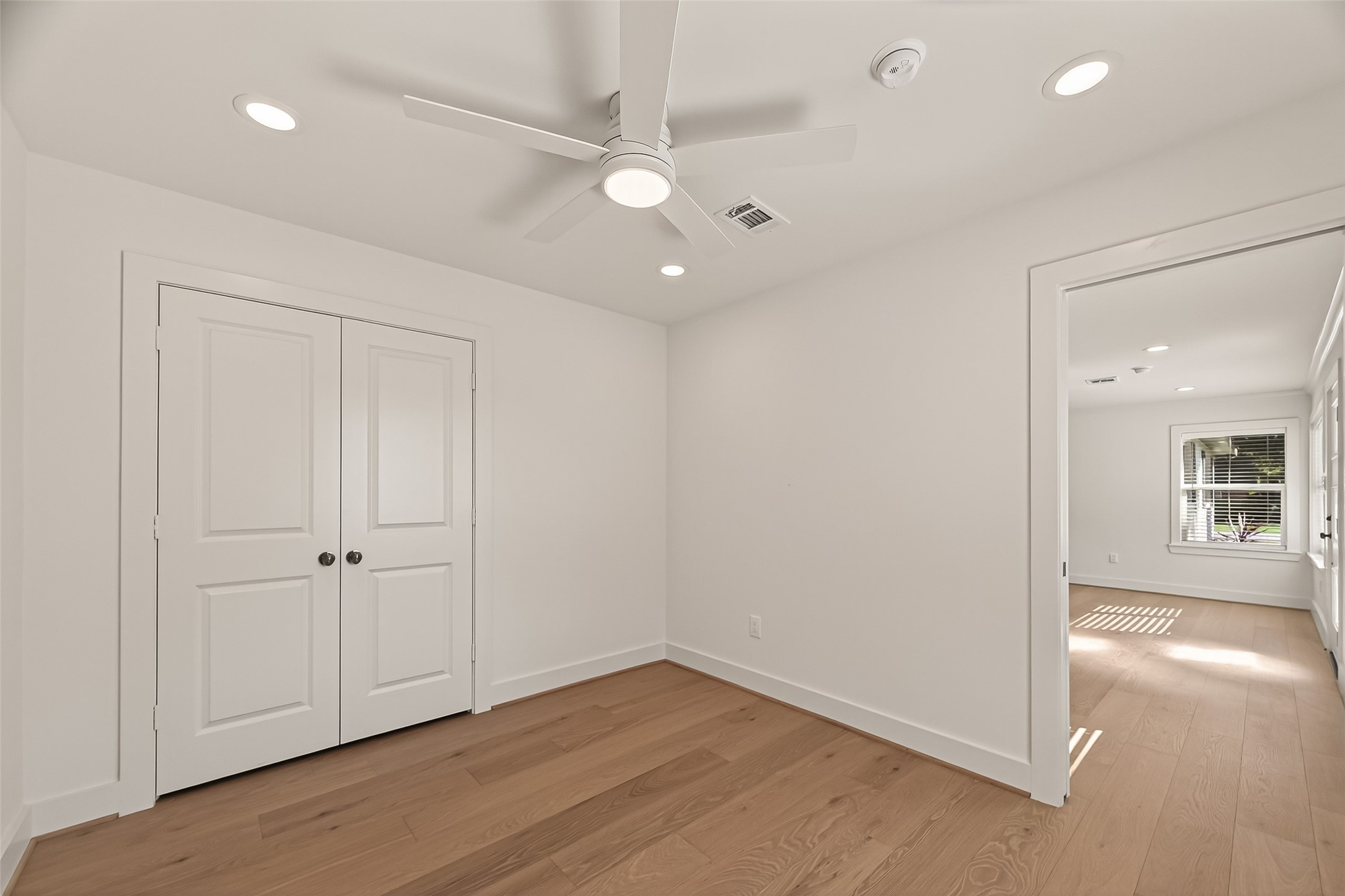 9242 Autauga Street Houston, TX 77080 - Photo 20 of 49 an empty room with wooden floor and windows