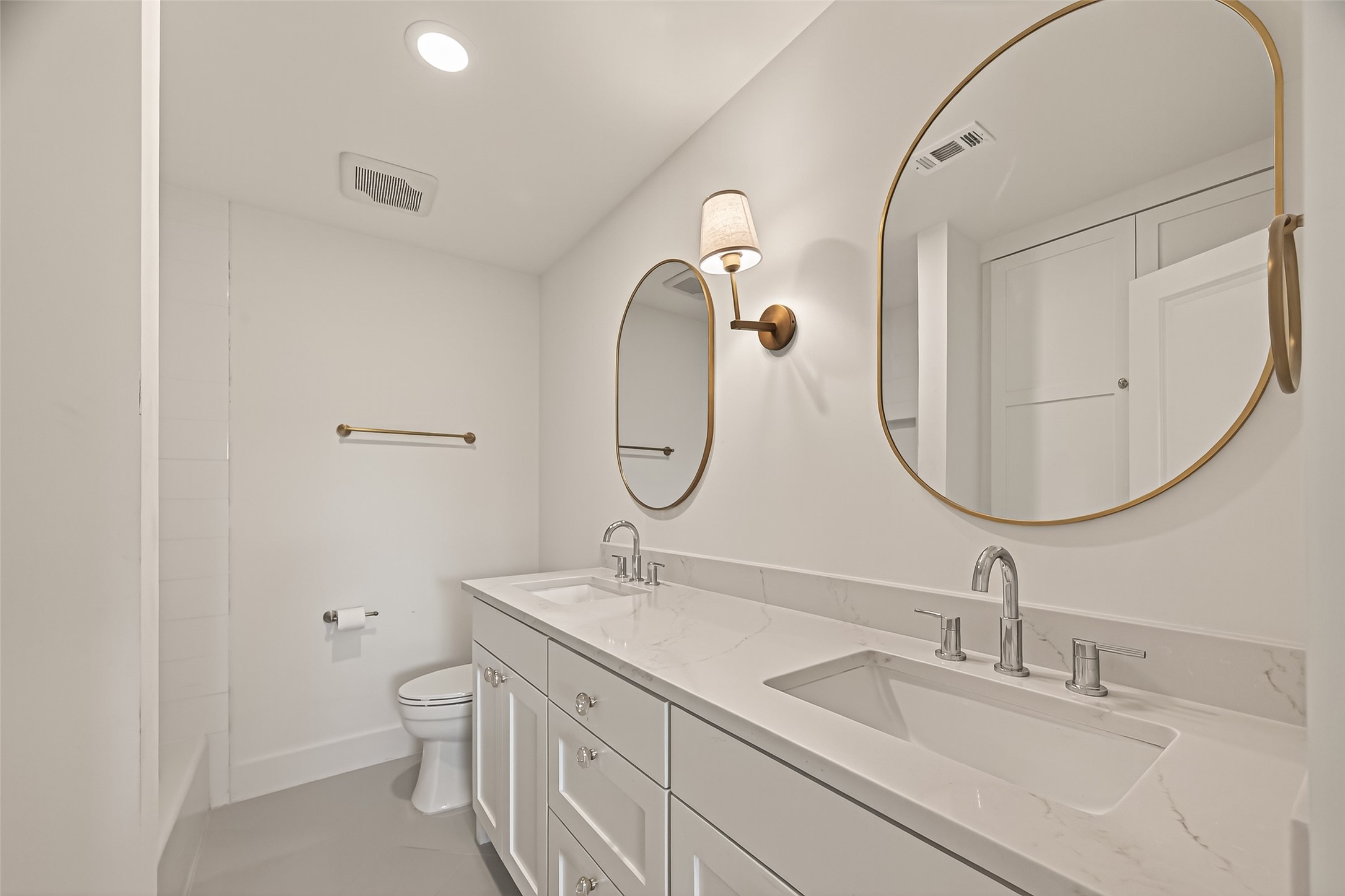 9242 Autauga Street Houston, TX 77080 - Photo 22 of 49 a bathroom with a double vanity sink and a mirror