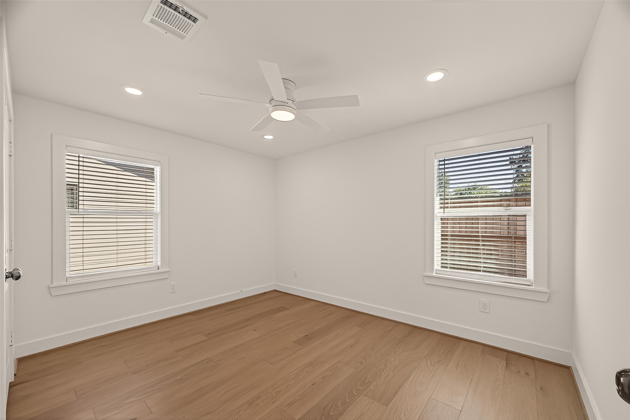 9242 Autauga Street Houston, TX 77080 - Photo 29 of 49 an empty room with wooden floor and windows