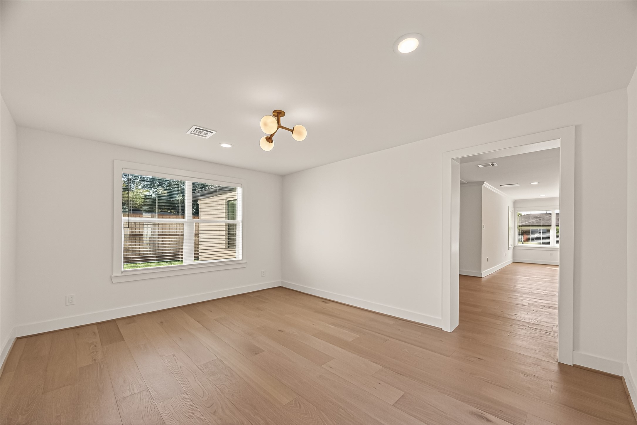 9242 Autauga Street Houston, TX 77080 - Photo 33 of 49 wooden floor in an empty room with a window