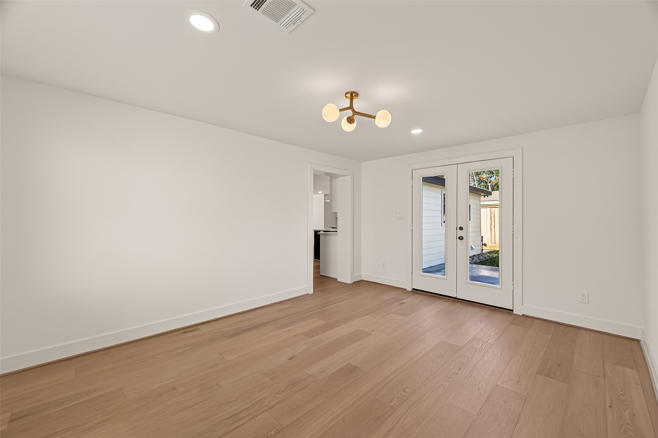 9242 Autauga Street Houston, TX 77080 - Photo 34 of 49 an empty room with wooden floor and windows
