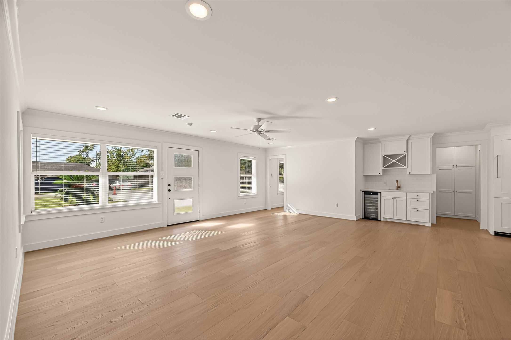 9242 Autauga Street Houston, TX 77080 - Photo 8 of 49 a view of an empty room with a window and wooden floor