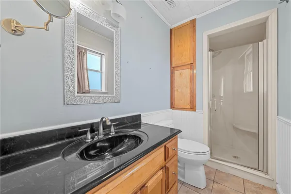 a bathroom with a sink a toilet and a window