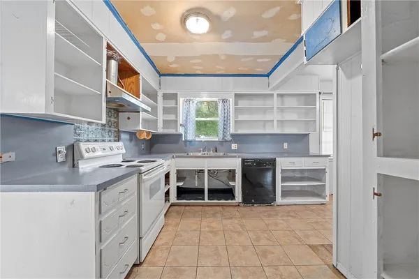a kitchen with a sink stove and cabinets