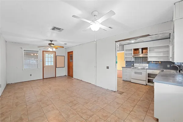 a view of a kitchen with a sink and dishwasher refrigerator stove