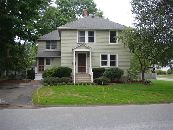 18 Willow Road Wellesley, MA 02482 - Photo 1 of 1 a front view of a house with a yard and garage