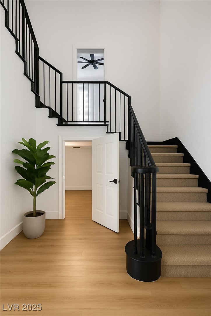 7 Summit Walk Trail Henderson, NV 89052 - Photo 21 of 61 Stairway with wood finished floors, a towering ceiling, and a ceiling fan
