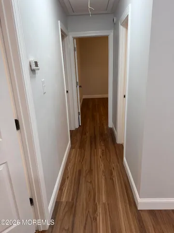 a view of a room with wooden floor