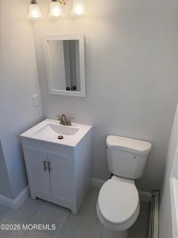 a white toilet sitting next to a bathroom sink